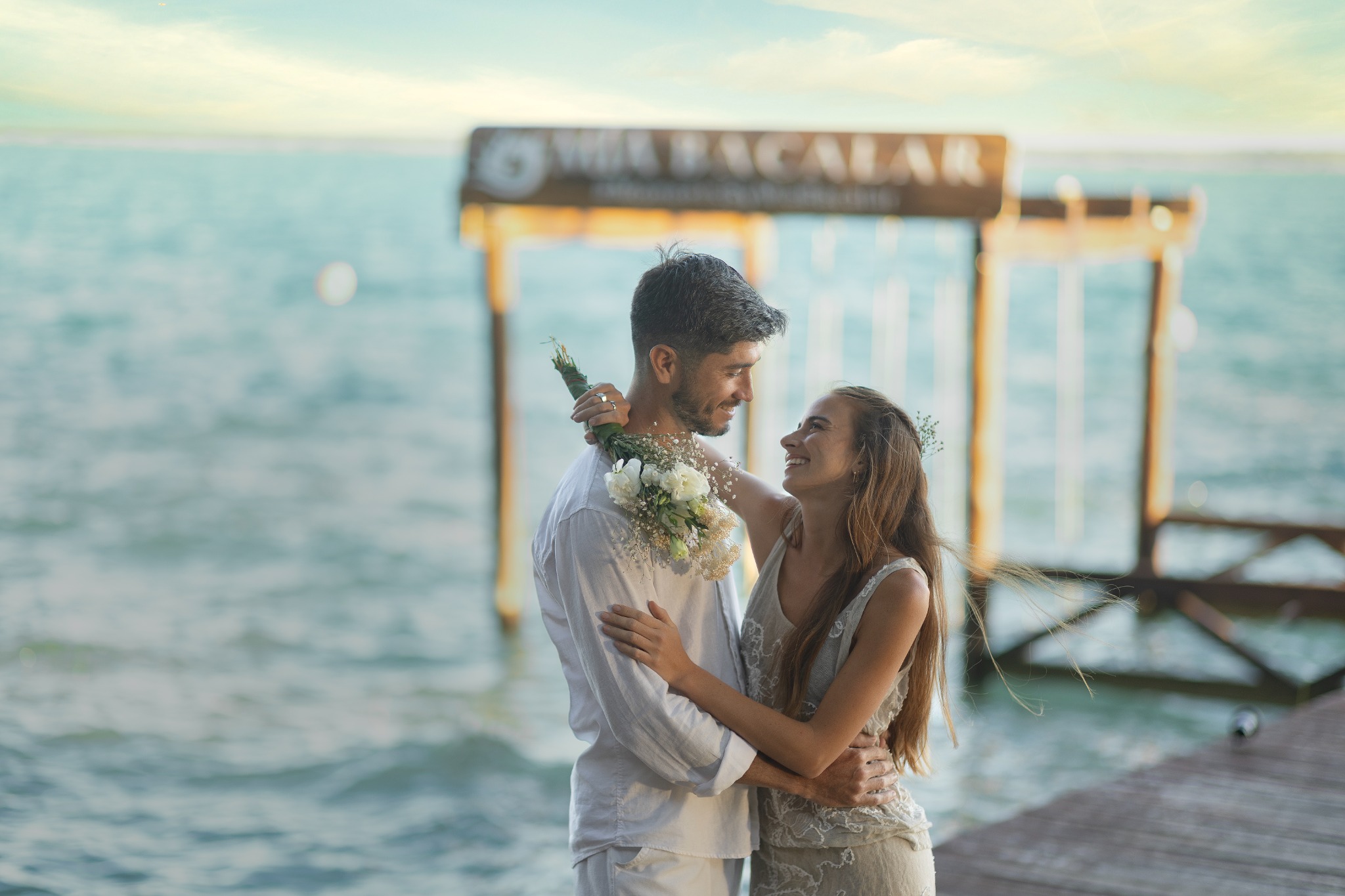 Couple celebrating on the pier at Mía Bacalar